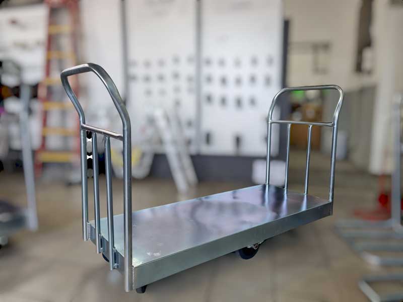Heavy-duty steel platform trolley with dual handles and castor wheels for industrial material handling by Reef Castor
