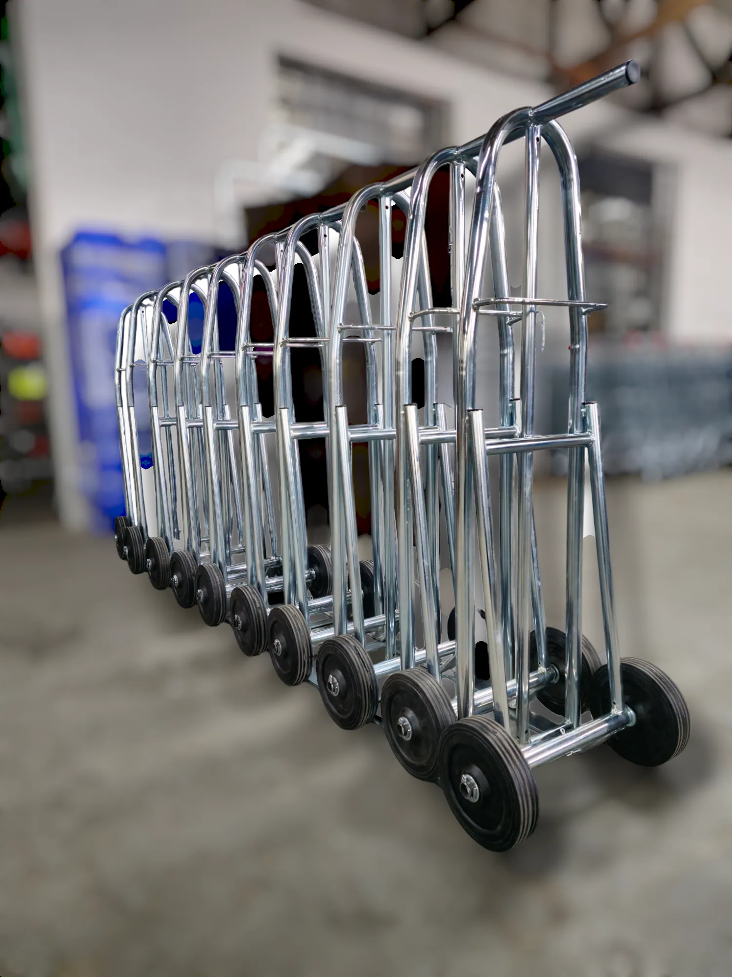 Steel hand trolleys lined up in warehouse ready for transport use